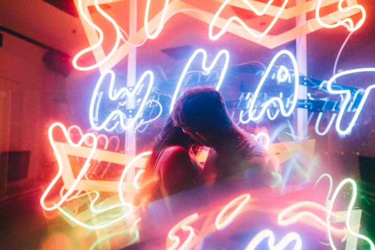 beautiful-couple-loving-each-other-surrounded-by-neon-lights-shot-with-slow-shutter